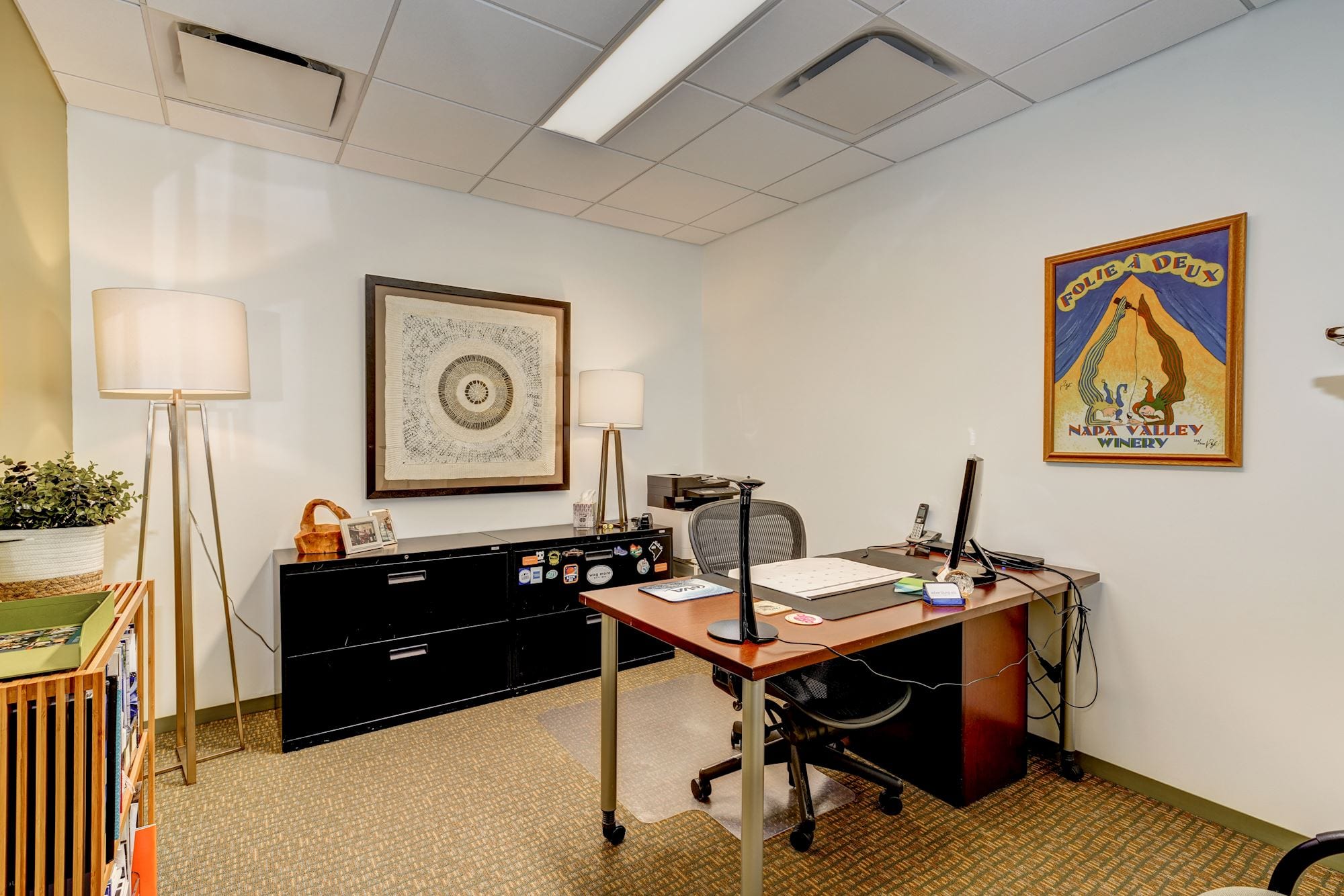Private office space with vibrant, psychedelic style artwork.
