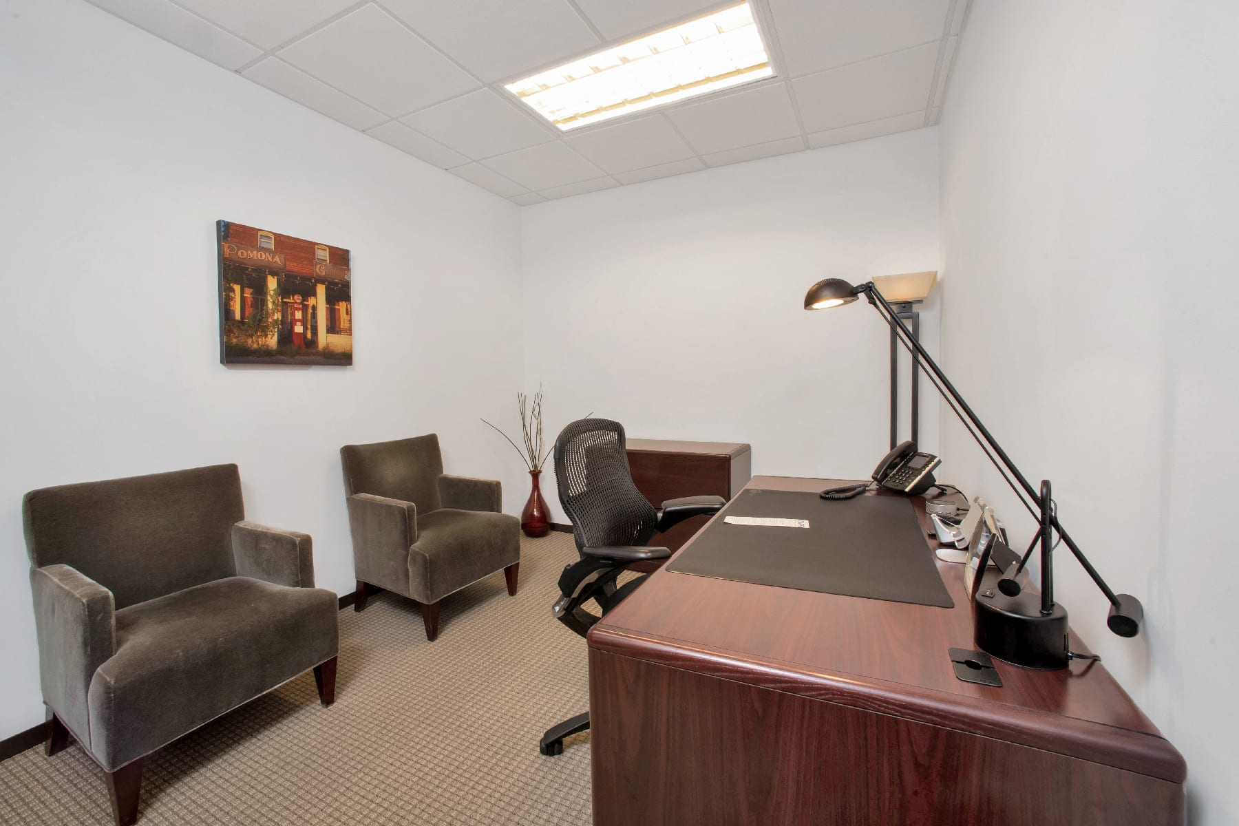Personal office with a desk and several comfortable chairs for guests.