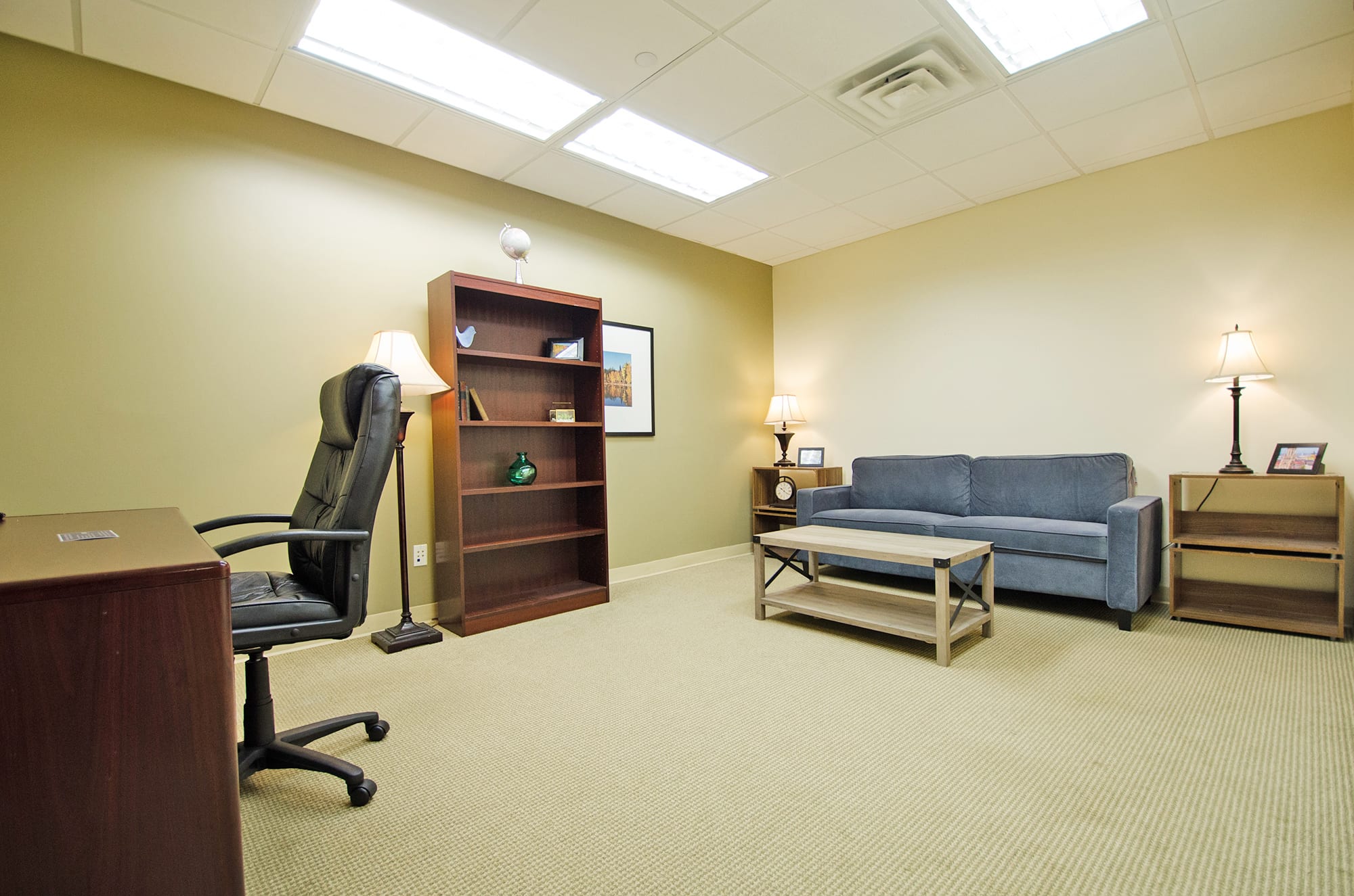 Cozy private office space with a desk and sofa at Carr Workplaces in Westchester